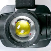 Close-up of a LEDLENSER H15R CORE headlamp on a white background