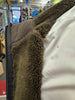 Close-up of a jacket with green fleece lining in a store setting