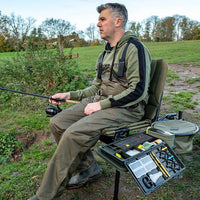 Korum S23 Accessory Chair (Standard) with angler fishing & accessory and bait boxes attached