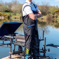 Match Angler standing next to Seatbox at River Bank wearing Preston Innovations Drifish Angling Bib & Brace